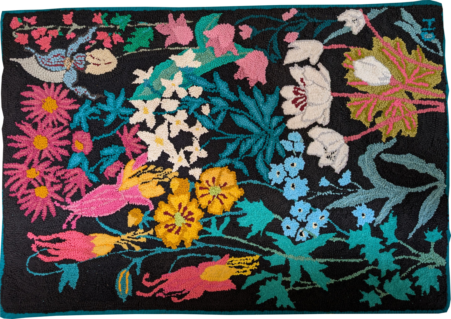 “Forget Me Nots and Friends” – colourful floral hand-hooked rug by Carmen Hall with vibrant blooms on a black background, made with wool, fleece, velour, and terrycloth.

