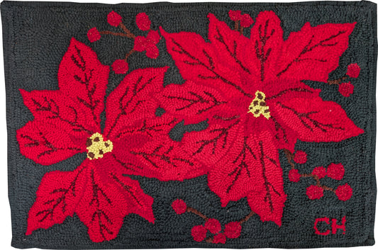 “Scarlet Cheer” – festive hand-hooked rug by Carmen Hall featuring two large red poinsettias with sparkling highlights on a dark background.


