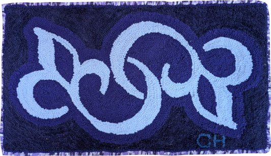 “Simplicity” – hand-hooked rug by Carmen Hall featuring a flowing abstract blue design on a deep blue background.